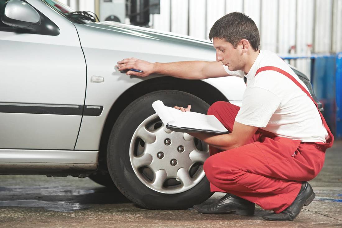 man is checking the car