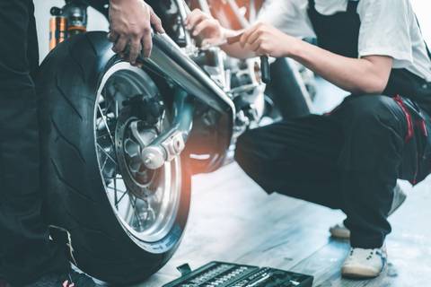 motorcycle Motorrad wheel checking man repairing motorcycle